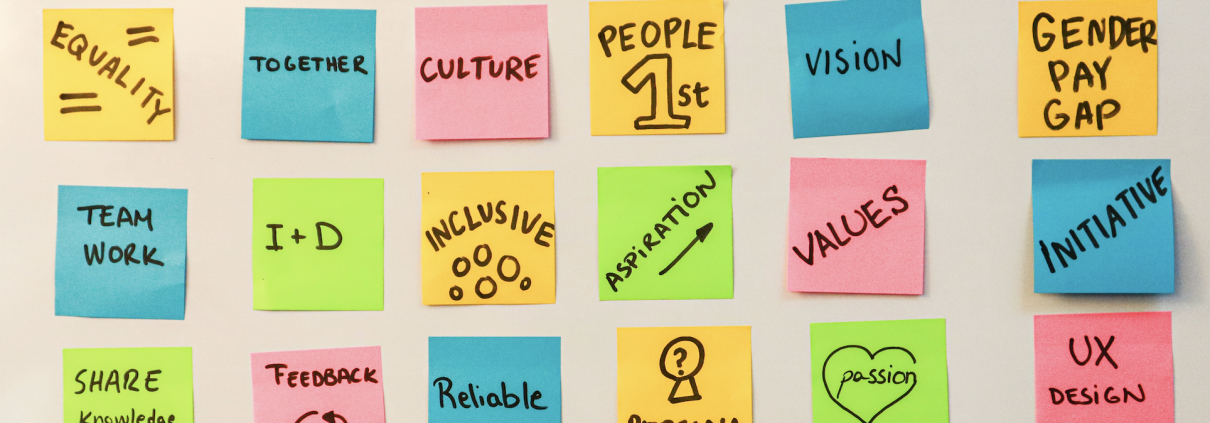 Sticky notes with workplace culture values like teamwork, inclusion, and reliability, representing rebuilding trust after high turnover