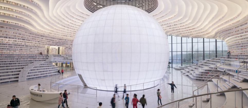 Modern library atrium with a large white sphere, illustrating an open enrollment communication blueprint for employers
