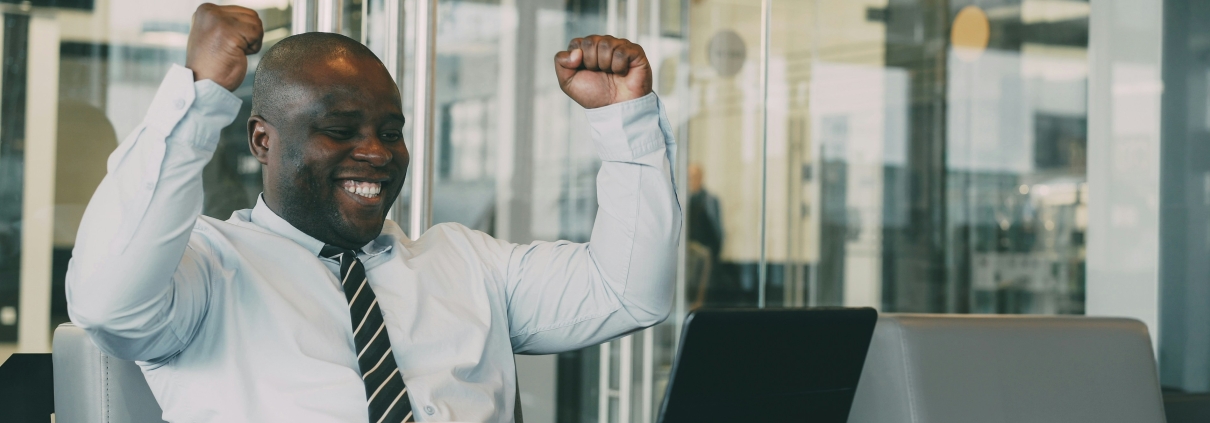 New employee celebrating success after finishing onboarding beyond the first 90 days