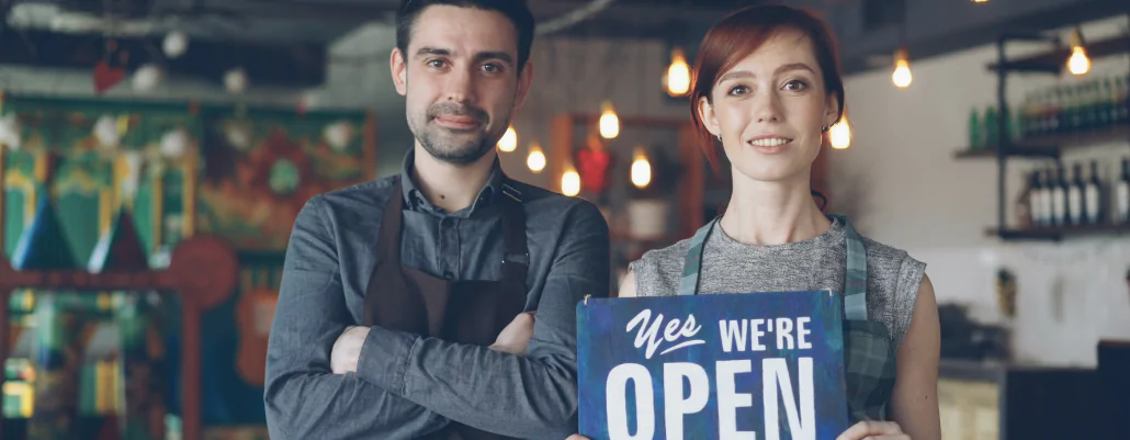 Small business owner reviewing PEO benefits including payroll, compliance, and HR technology solutions