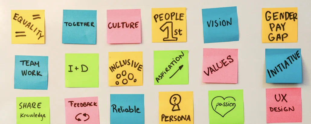 Sticky notes with workplace culture values like teamwork, inclusion, and reliability, representing rebuilding trust after high turnover
