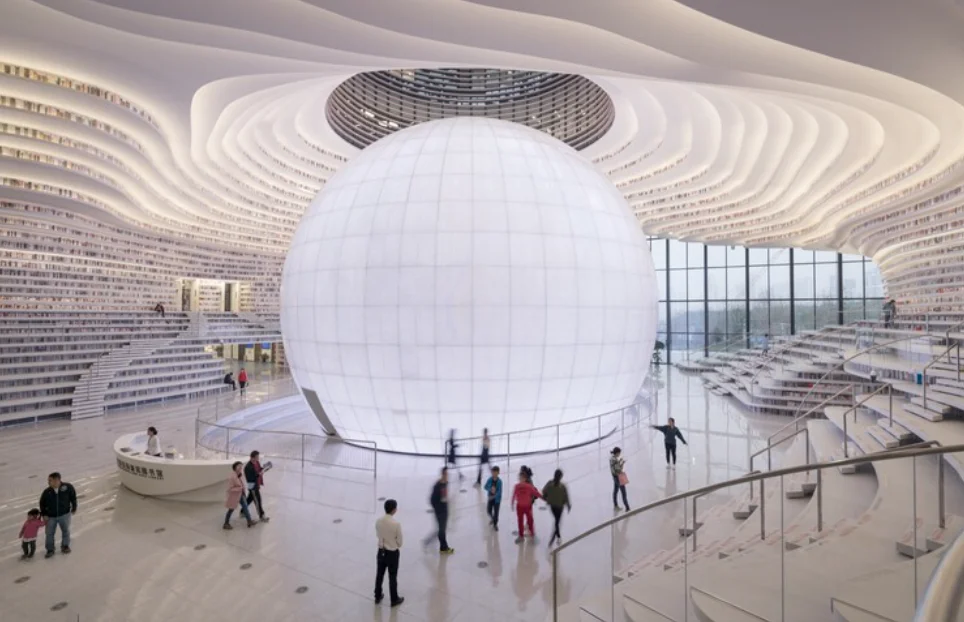 Modern library atrium with a large white sphere, illustrating an open enrollment communication blueprint for employers