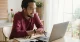 Employee reviewing employee benefits options on a laptop before open enrollment